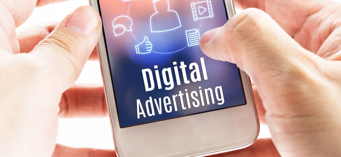 Close up hand holding mobile with Digital Advertising and icons,